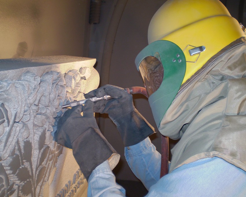 Man making a rose engraving in stone